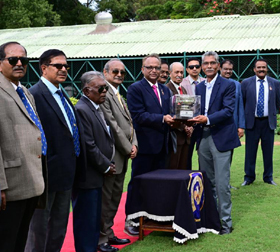 Mysore Race Club Chairman Y B Ganesh presenting the Chief Minister’s Trophy to Dean Stephens whose horse Seige Perilous won this event at Mysore on Thursday.